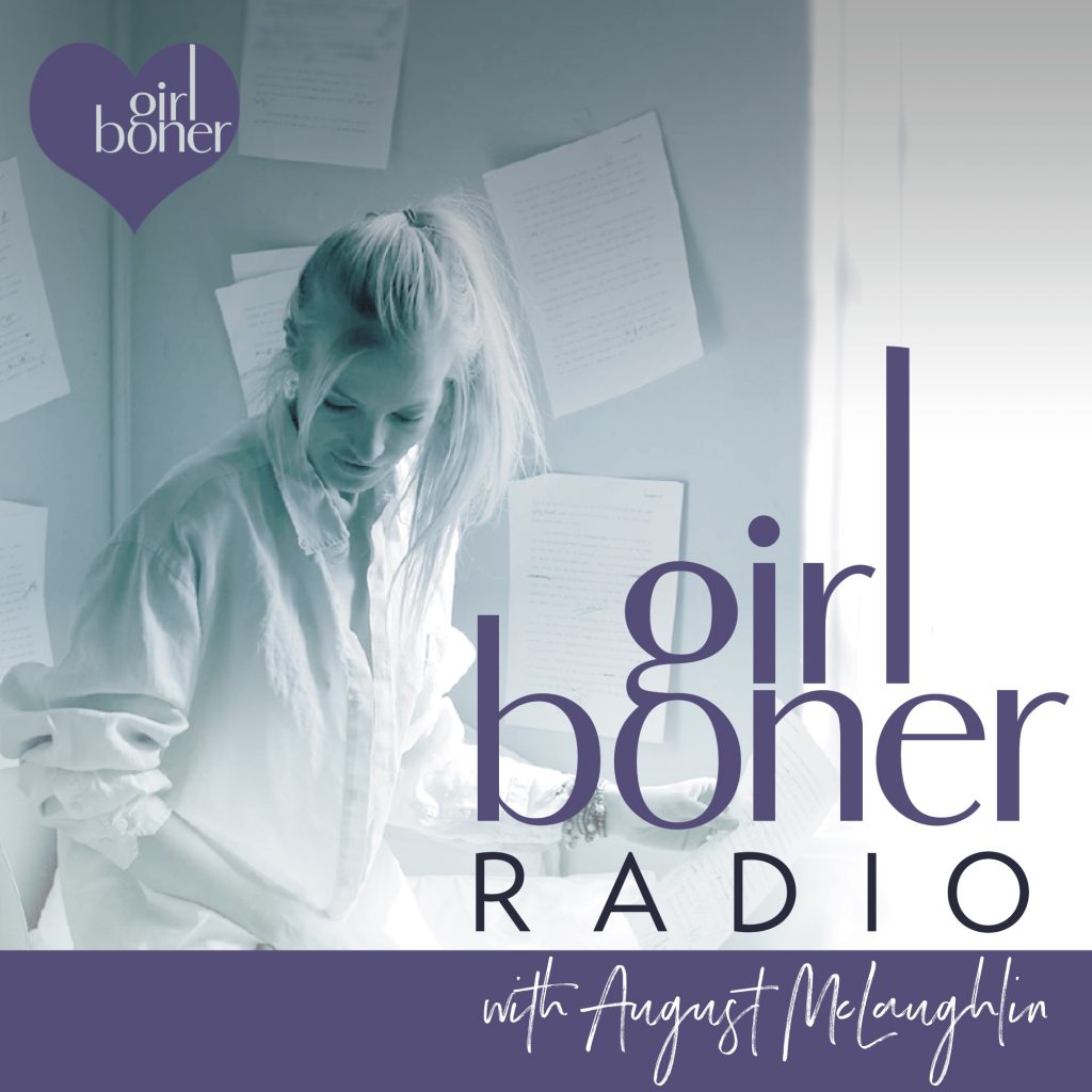 Promotional graphic for Girl Boner Radio with August McLaughlin, featuring a monochrome photo of a woman in a white shirt standing in front of papers on a wall, with large purple and black text and a purple heart logo reading 'girl boner'.
