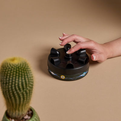 A finger pressing a button on the shock roulette detector set