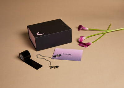 Closed Saturday Box with assorted props from Loose Lips set on a brown background