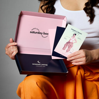 Woman holding Hard Time Eco box and some of its cards all fanned out