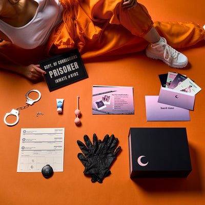 Collection of items from Hard Time Classic Box displayed flat on an orange background