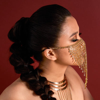 Woman wearing Arabian Nights Bejeweled Veil and braided hair against a red background